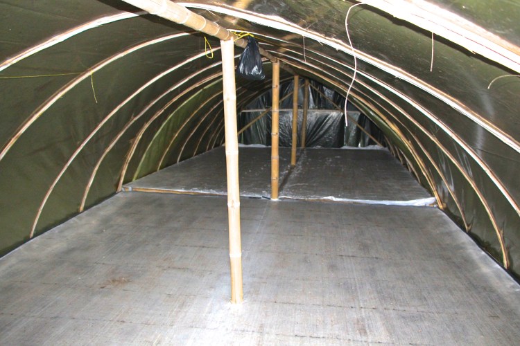 The pulped and fermented beans are spread out on drying tables or floors to 11% moisture. The dried beans are known as "parchment coffee" as they still contain a parchment layer. After drying, beans are sent to a mill where hulling machinery removes this shell. 